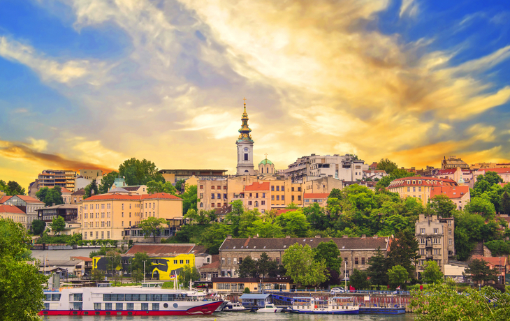 Panorama von Belgrads Skyline mit Fluss und Kirchturm im Hintergrund.